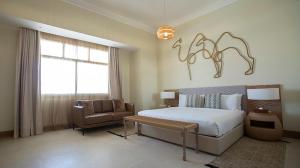 Voodi või voodid majutusasutuse Liwa Hotel toas