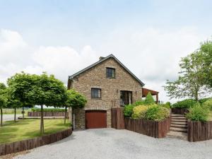 a stone house with a gate and a driveway at Magnificent Villa in Brisy with Sauna Roofed Terrace and BBQ in Brisy