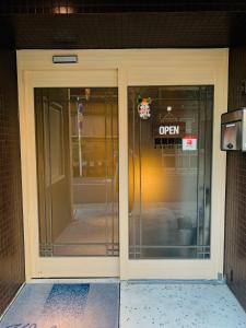 an open door on a building with a sign on it at Tabist Wa Style Tokyo in Kawaguchi