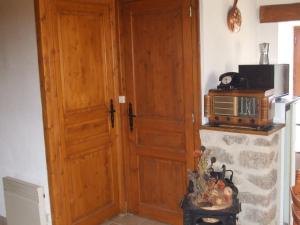 a kitchen with a wooden door and a microwave at Beautiful holiday home with mountain view in Sauvain