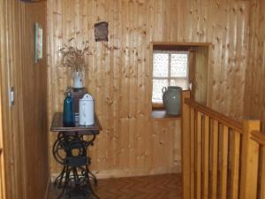 a room with a wooden wall with a window and a table at Beautiful holiday home with mountain view in Sauvain