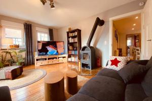 a living room with a couch and a fireplace at Gemütliche Landhaus Wohnung auf dem Ponyhof - Himmelbett, Kamin & Garten in Ortenberg