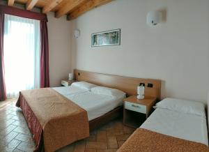 Postel nebo postele na pokoji v ubytování Hotel Agli Ulivi