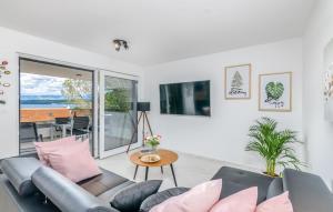 a living room with a couch and a table at Apartments Elle Luxury Vantačići in Malinska