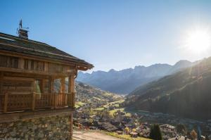 a building with a view of a valley at La Ferme de Juliette in Le Grand-Bornand