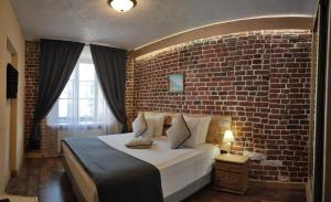 
a large white bed sitting in front of a large window at Hotel Maroseyka 2/15 in Moscow

