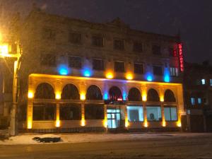 a building with blue and yellow lights on it at Midyat GAP Hotel in Midyat +16 photos