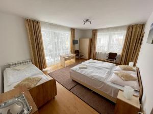 a hotel room with two beds and a window at Dom Wczasowy Anna in Rabka