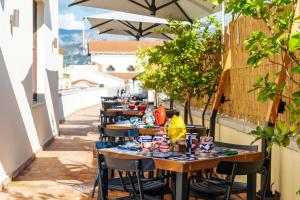 a row of tables on a patio with umbrellas at Maison Il Conservatorio in Sorrento