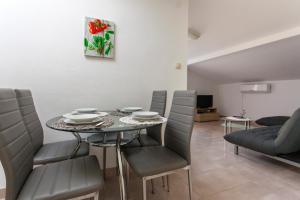ein Esszimmer mit einem Tisch und Stühlen in der Unterkunft Apartments Katarina B in Sveti Vid-Miholjice