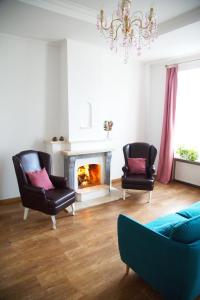 a living room with two chairs and a fireplace at Kashtan guest house in Kyiv