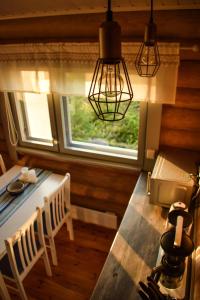 a dining room with a table and a window at Loma-Autio Apaja in Puumala