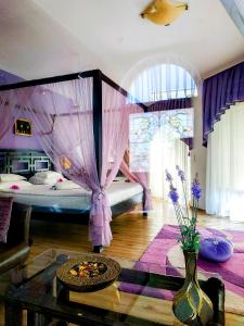 
a room with a bed, a table, and a window at Art Hotel Nirvana in Shumen
