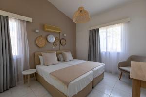 a bedroom with a large bed in a room at Socrates Apartments in Polis Chrysochous +32 photos