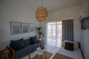 a living room with a couch and a window at Socrates Apartments in Polis Chrysochous