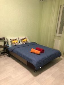 a bed with two pillows on it in a room at Улица Склизкова д116 к.6 in Tver
