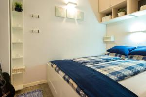 - une chambre avec un lit et des oreillers bleus dans l'établissement Apartment Mani, à Dubrovnik