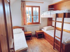a room with two bunk beds and a window at Pohorje Village Wellbeing Resort - Forest Apartments Videc in Hočko Pohorje +109 photos