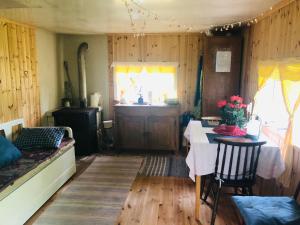 a dining room with a table and a window at Tiny hut in the forest overlooking the river in Avesta