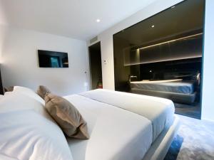 a white bed in a bedroom with a large window at Bv hotel in Brignano Gera dʼAdda +32 photos
