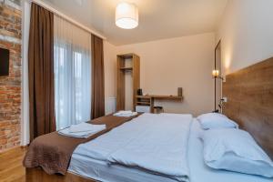 a bedroom with a large bed with blue sheets at Hotel Green Town in Kutaisi +37 photos