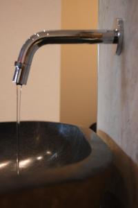 un lavandino in bagno con rubinetto d'acqua di Gasthof-Pension Zum Haugstein - Familie Eder a Engelhartszell