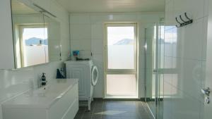 a bathroom with a shower and a sink and a toilet at Lilleeideholmen Sjøhusutleie in Haug +42 photos