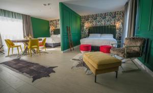 a hotel room with a bed and a table and chairs at HOLM Boutique & SPA - IK Collection in St. Julianʼs