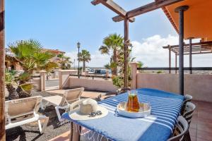 a table with a bowl of food on a patio at Pierre & Vacances Resort Fuerteventura OrigoMare in Lajares