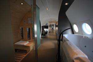 En eller flere senge i et værelse på Vliegtuigsuite Teuge