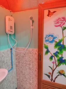 y baño con ducha, aseo y lavamanos. en บ้านพักกลางนา en Amphoe Sawang Daen Din