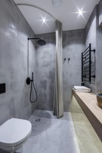 a bathroom with a toilet and a shower at Laisves ave. Apartments Mini in Kaunas