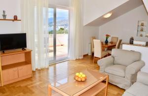 a living room with a couch and a television at Pervanovo Apartments with Free Parking in Dubrovnik