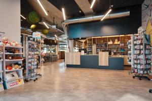 a grocery store aisle with a counter and shelves of products at Jugendherberge Oldenburg "DJH Mitgliedschaft erforderlich - membership required" in Oldenburg