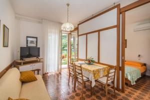 a living room with a table and a bed and a bedroom at Apartments Ljerka in Rabac