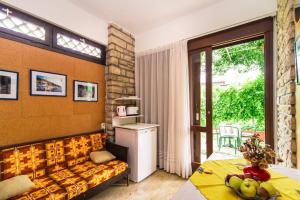 a living room with a couch and a window at Apartments Ljerka in Rabac