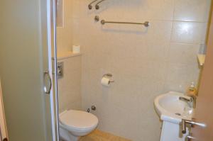 a bathroom with a toilet and a sink at Apartments Vilim Tisno in Tisno +14 photos