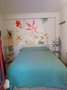 a bedroom with a bed with birds on the wall at les Hauts du Lac in Sainte-Croix-de-Verdon