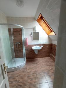 a bathroom with a shower and a sink at Holiday Apartmanház in Zalakaros