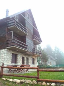 a large building with benches in front of it at Apartments Sara in Žabljak