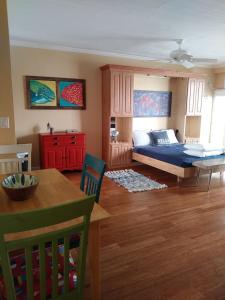 a bedroom with a bed and a dining room at Beach Getaway III at Belleview in Clearwater Beach