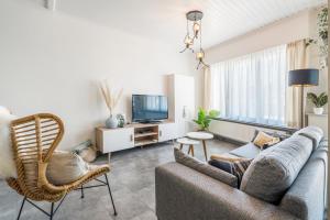 ブランケンベルヘにあるGreat holiday House for 6 people at Blankenbergeのソファとテレビのあるリビングルーム