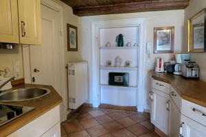 a kitchen with a sink and a counter top at Herrenhaus Borghorst in Osdorf