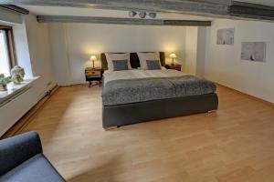 a large bedroom with a bed and two tables at fewo1846 - An der alten Kaffeerösterei - stilvoll eingerichtete 2-Zimmer-Wohnung im Stadtzentrum in Flensburg