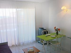 a living room with a green table and chairs at Apartment Savanna Beach I-2 by Interhome in Cap d'Agde