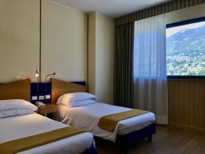 Postel nebo postele na pokoji v ubytování Hotel Express Aosta East