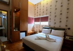 Postel nebo postele na pokoji v ubytování Omah Qu Guesthouse Malioboro