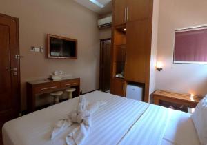 Postel nebo postele na pokoji v ubytování Omah Qu Guesthouse Malioboro