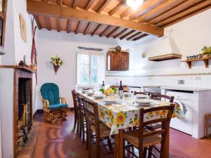 kuchnia ze stołem z krzesłami i kominkiem w obiekcie Holiday Home San Bernardino by Interhome w mieście Barga