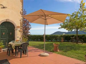 a table with an umbrella on a patio at Villa Luana by Interhome in Ruota